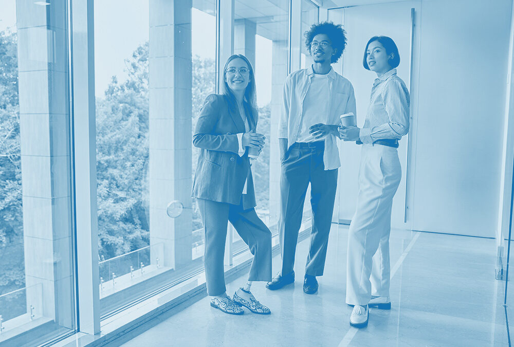 Three Office Workers Stood by a Window