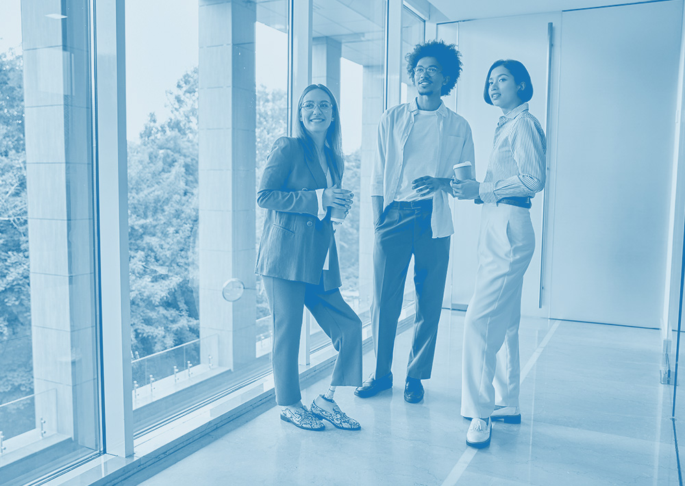 Three Office Workers Stood by a Window